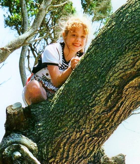 Beth and her smile climbs a tree...years ago! 