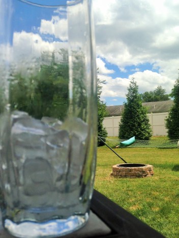 Fire Pit & Hammock with a Larger Than Life Glass of Water